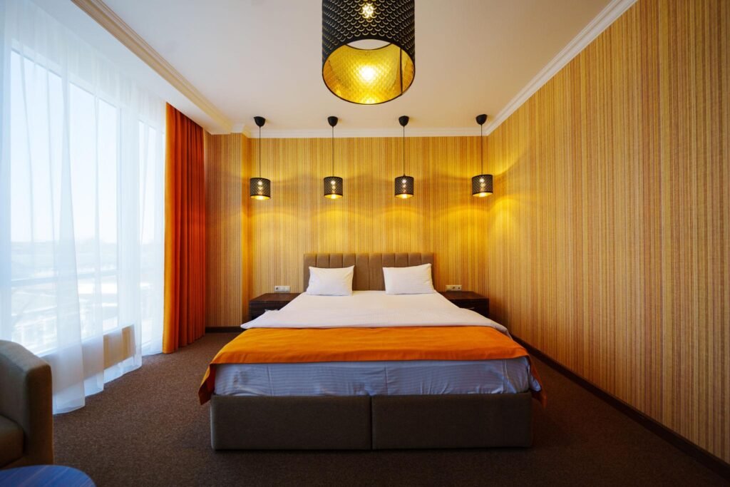 Modern bedroom interior with warm lighting and contemporary furniture styling.