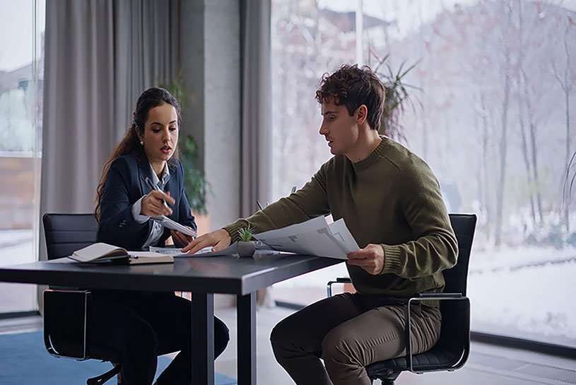 Professional interior designer discussing planning and design ideas with clients.
